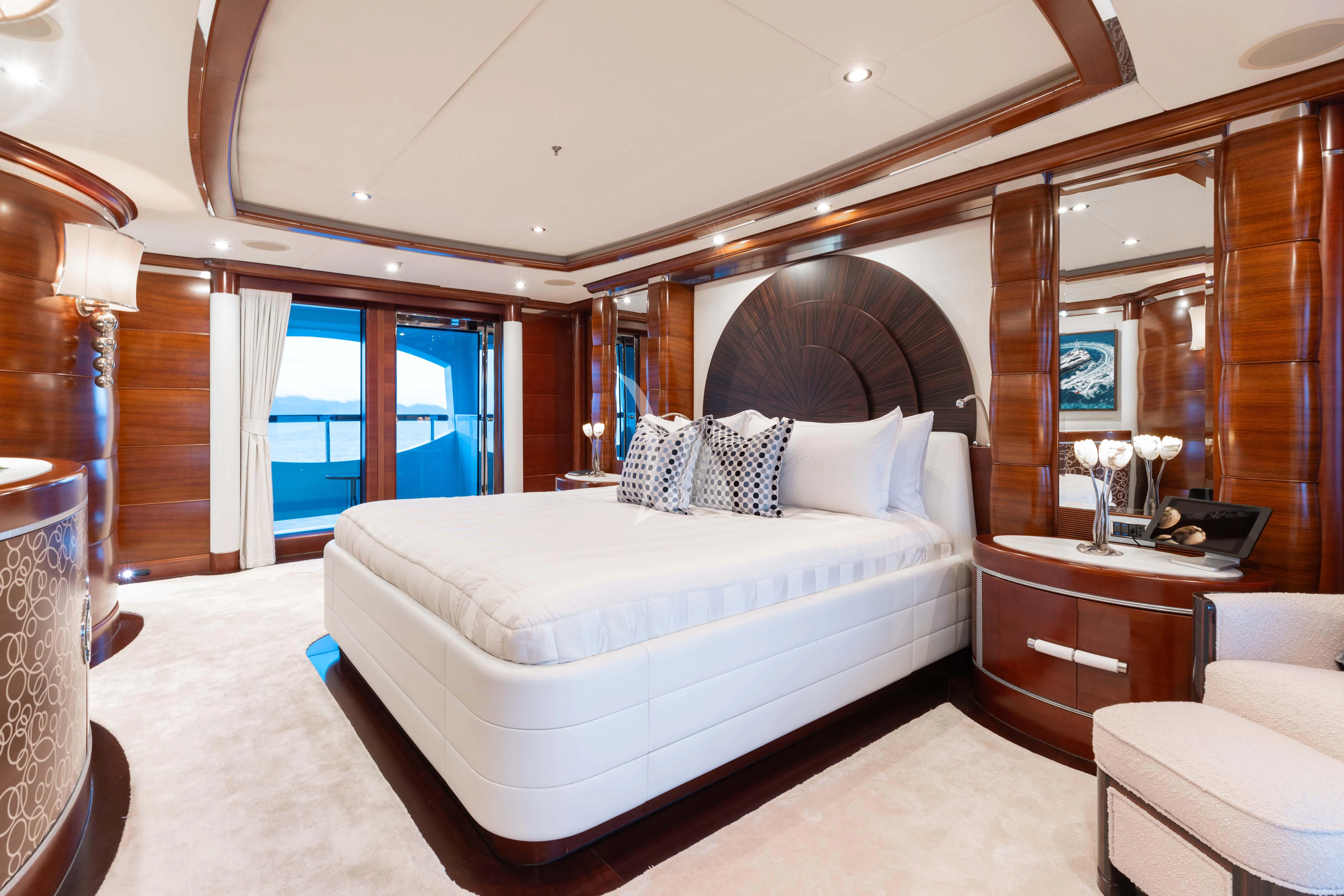 a bedroom with a large mirror aboard LADY B Yacht for Charter