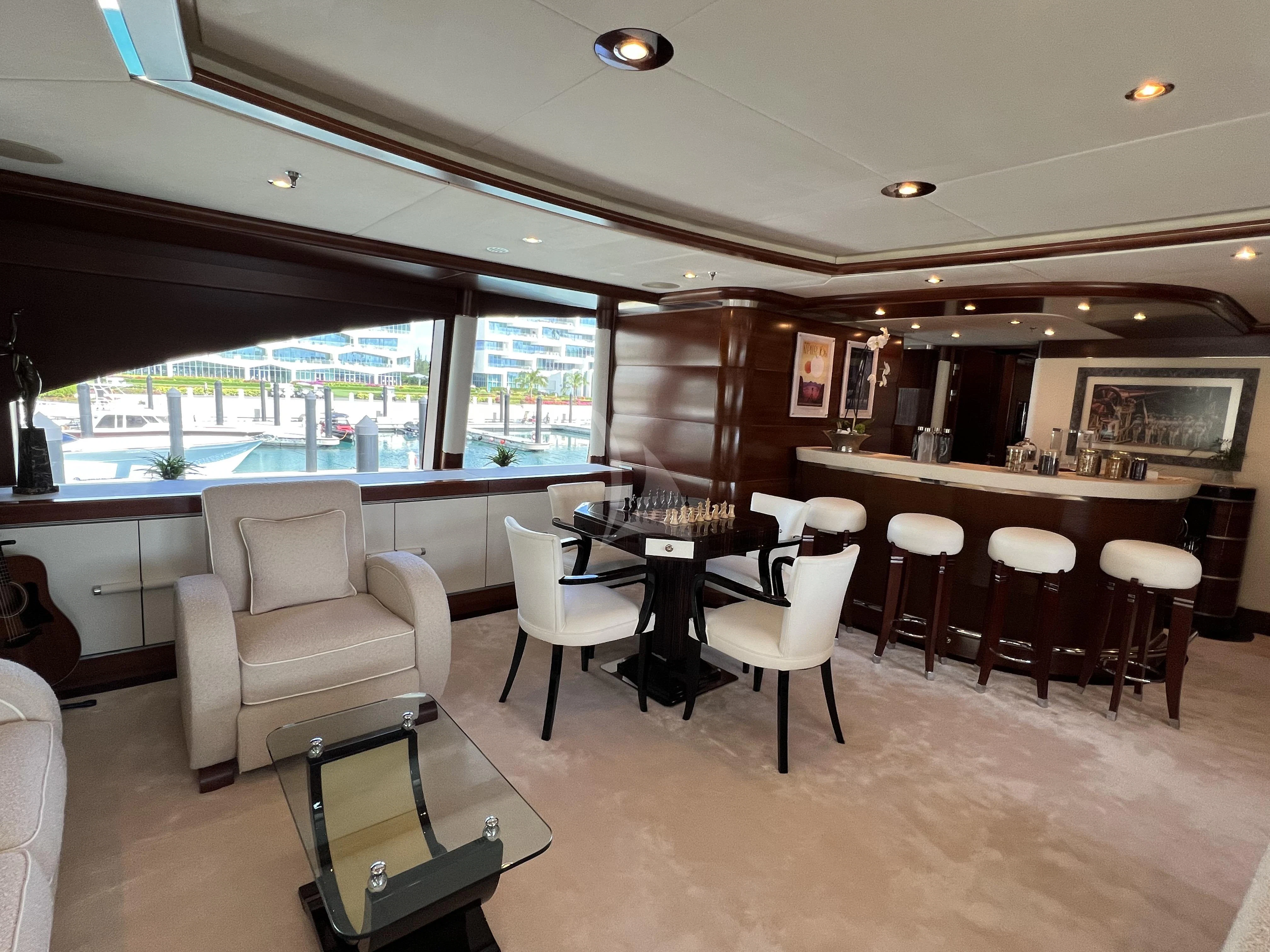 a room with a table and chairs aboard LADY B Yacht for Charter