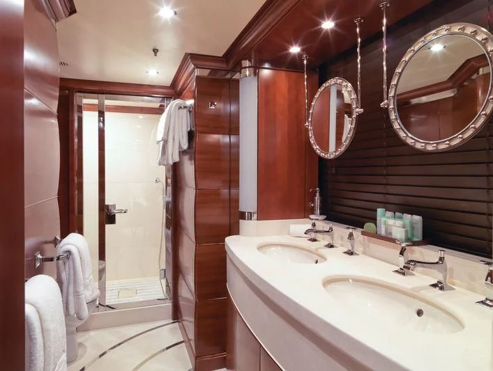 a bathroom with a sink and a mirror aboard LADY B Yacht for Charter