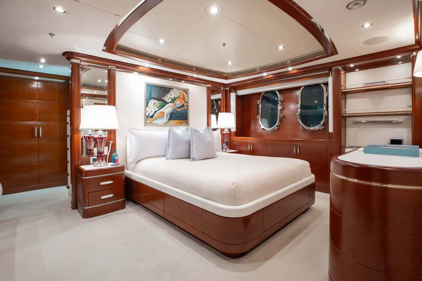 a bedroom with a bed and a mirror aboard LADY B Yacht for Charter