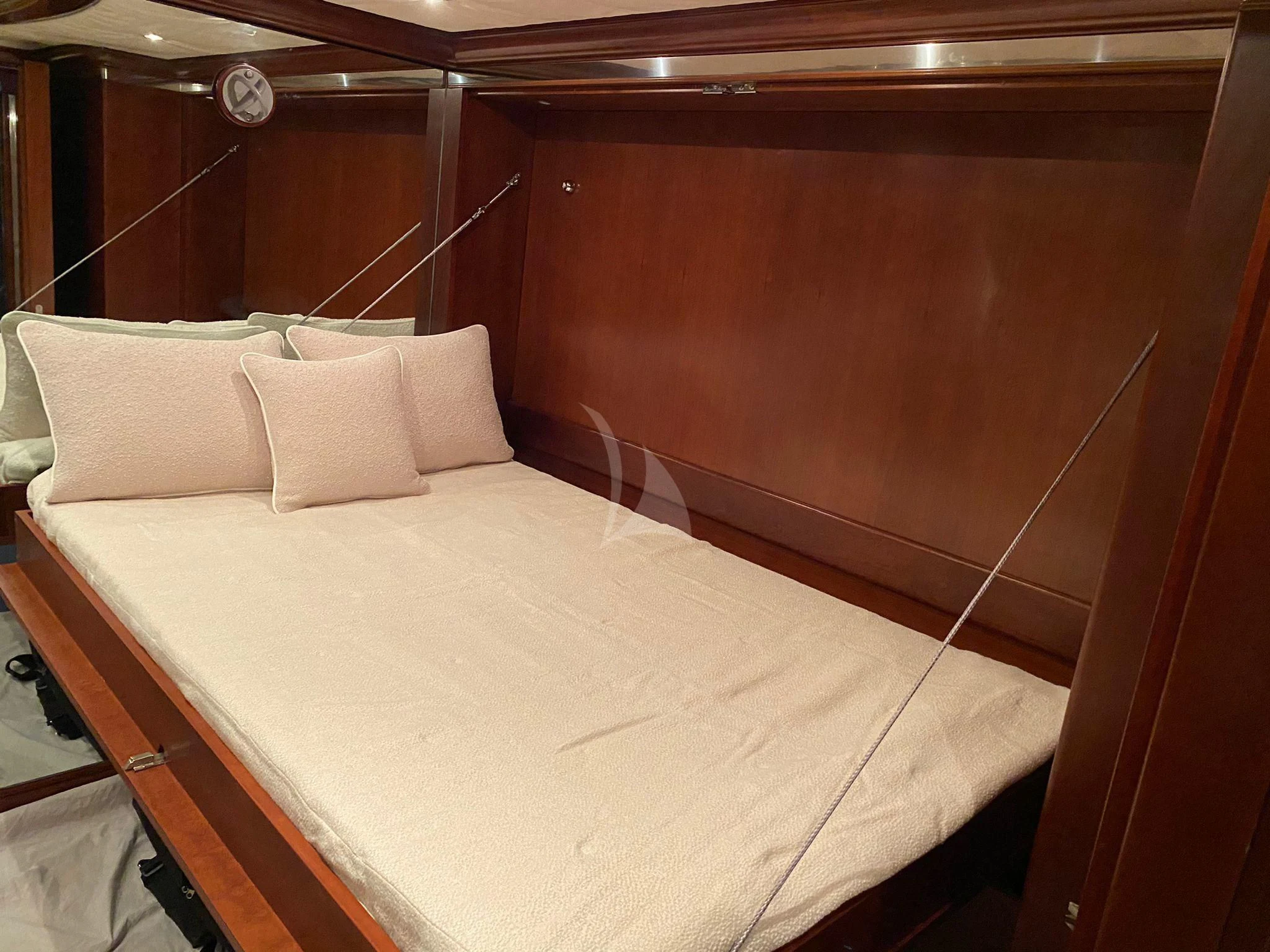 a bed with a white sheet and pillows on it aboard LADY B Yacht for Charter
