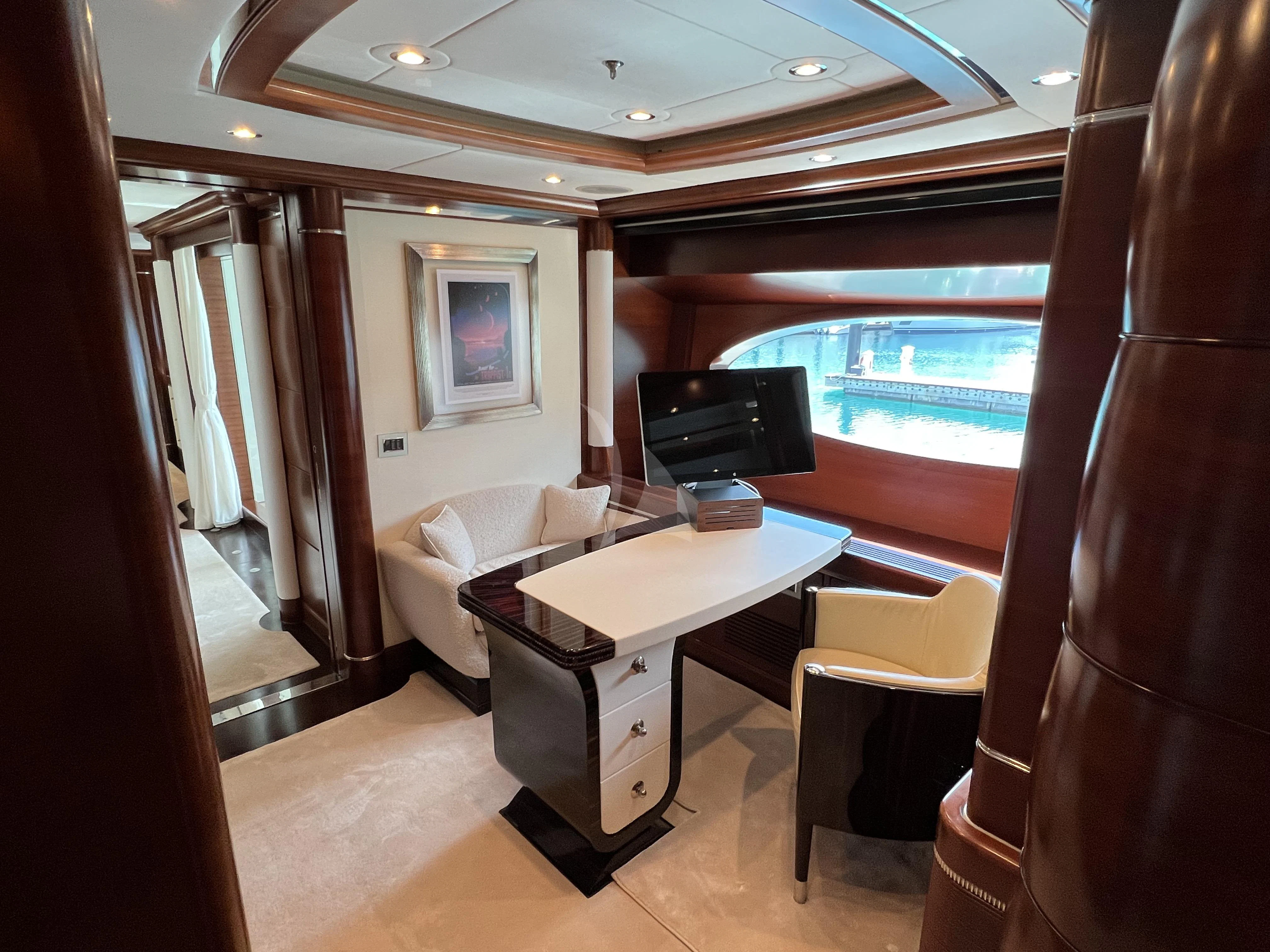 a room with a table and a tv aboard LADY B Yacht for Charter