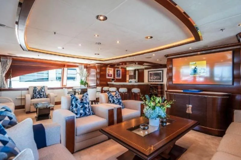 a living room with a large screen aboard LADY B Yacht for Charter