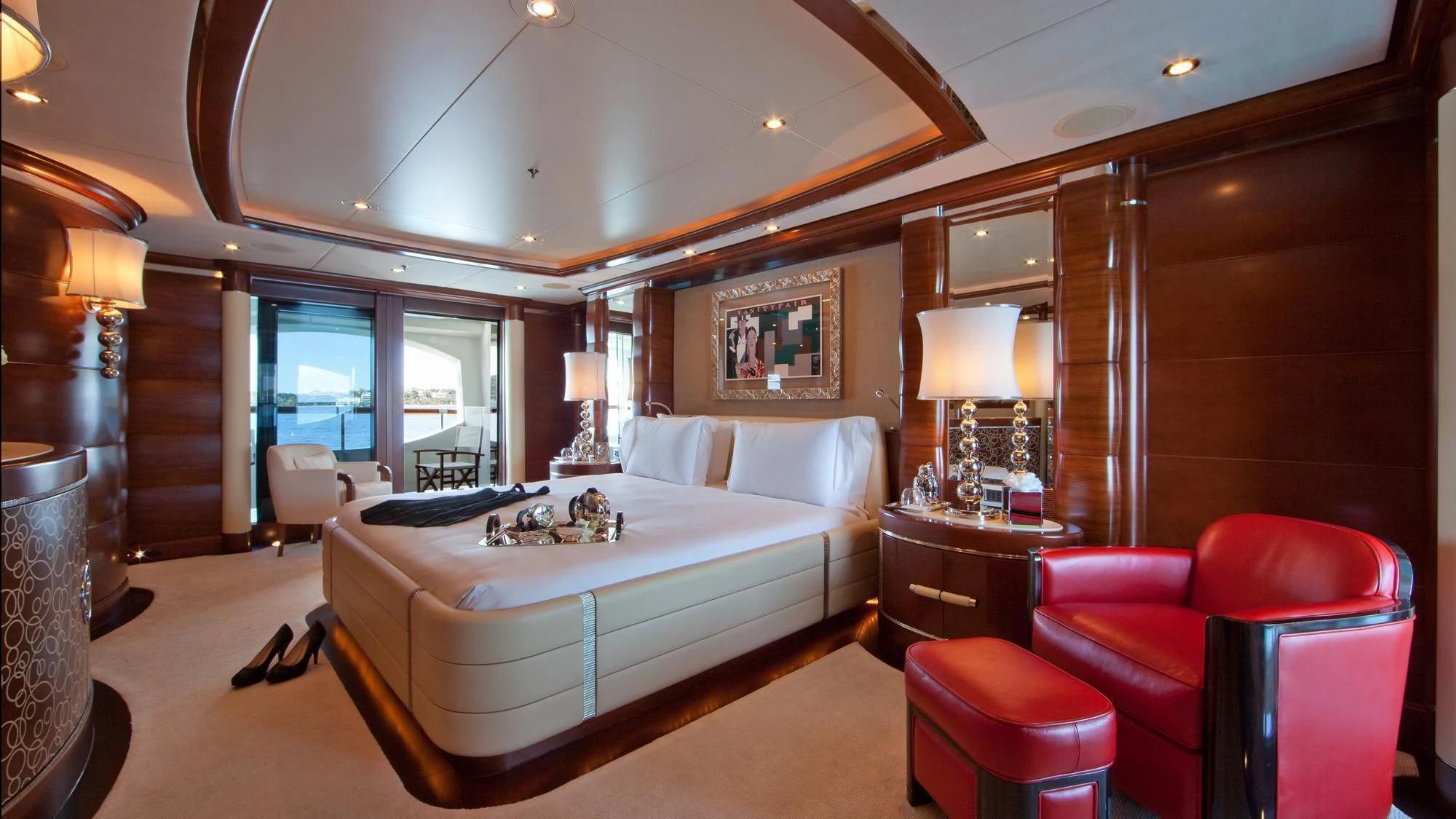 a large bedroom with a bed and a desk aboard LADY B Yacht for Charter