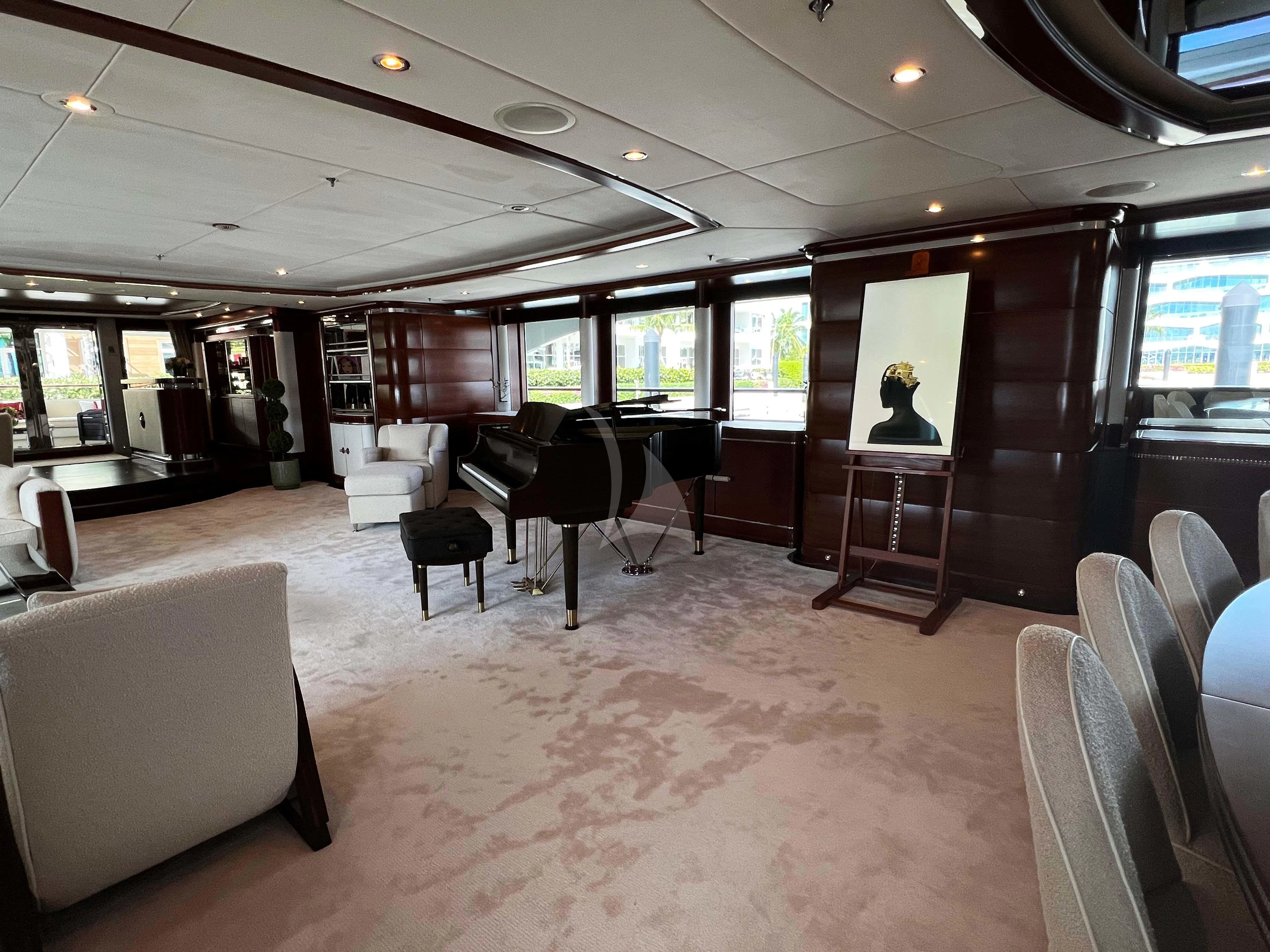 a room with chairs and a table aboard LADY B Yacht for Charter