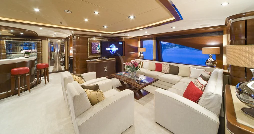 a room with a couch and a television aboard LADY B Yacht for Charter
