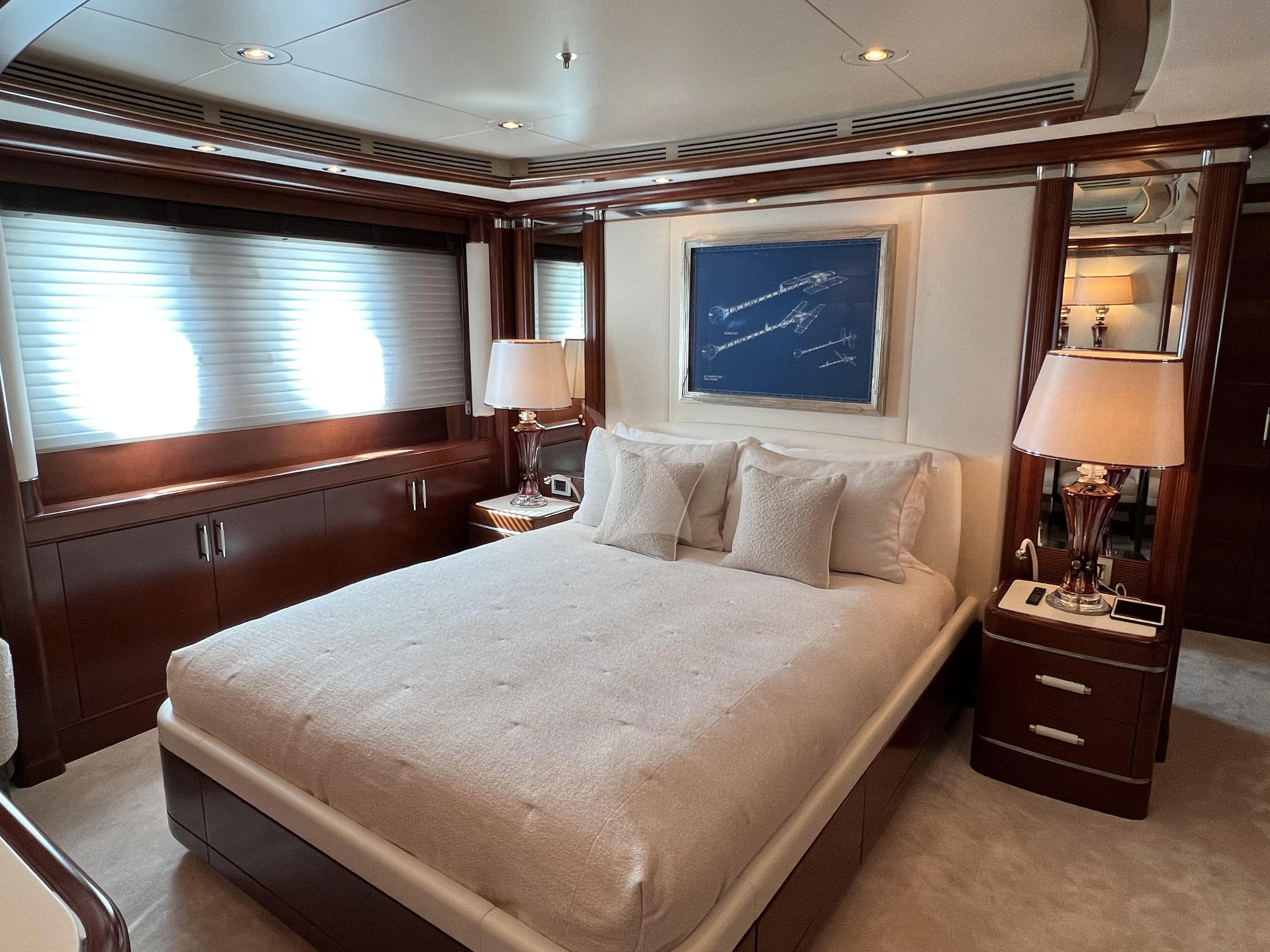 a hotel room with a bed and a large window aboard LADY B Yacht for Charter