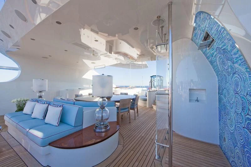 a room with a large bed and a table aboard LADY B Yacht for Charter