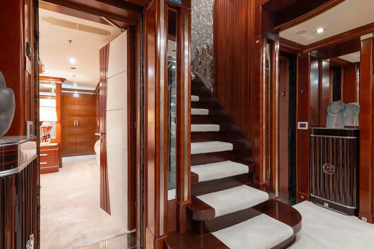 a hallway with a door and a staircase aboard LADY B Yacht for Charter