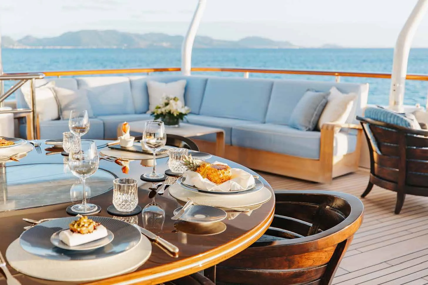 a table with plates and glasses on it aboard LADY B Yacht for Charter