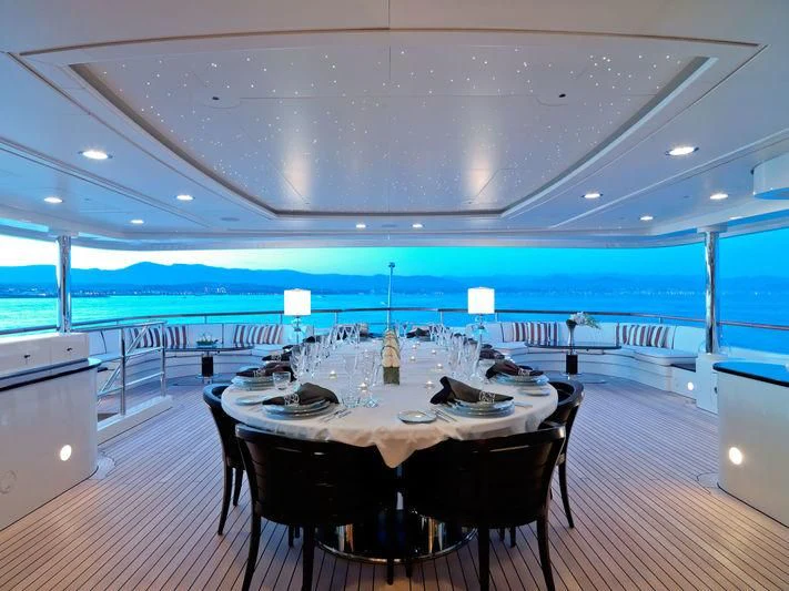 a large room with a table and chairs aboard LADY B Yacht for Charter