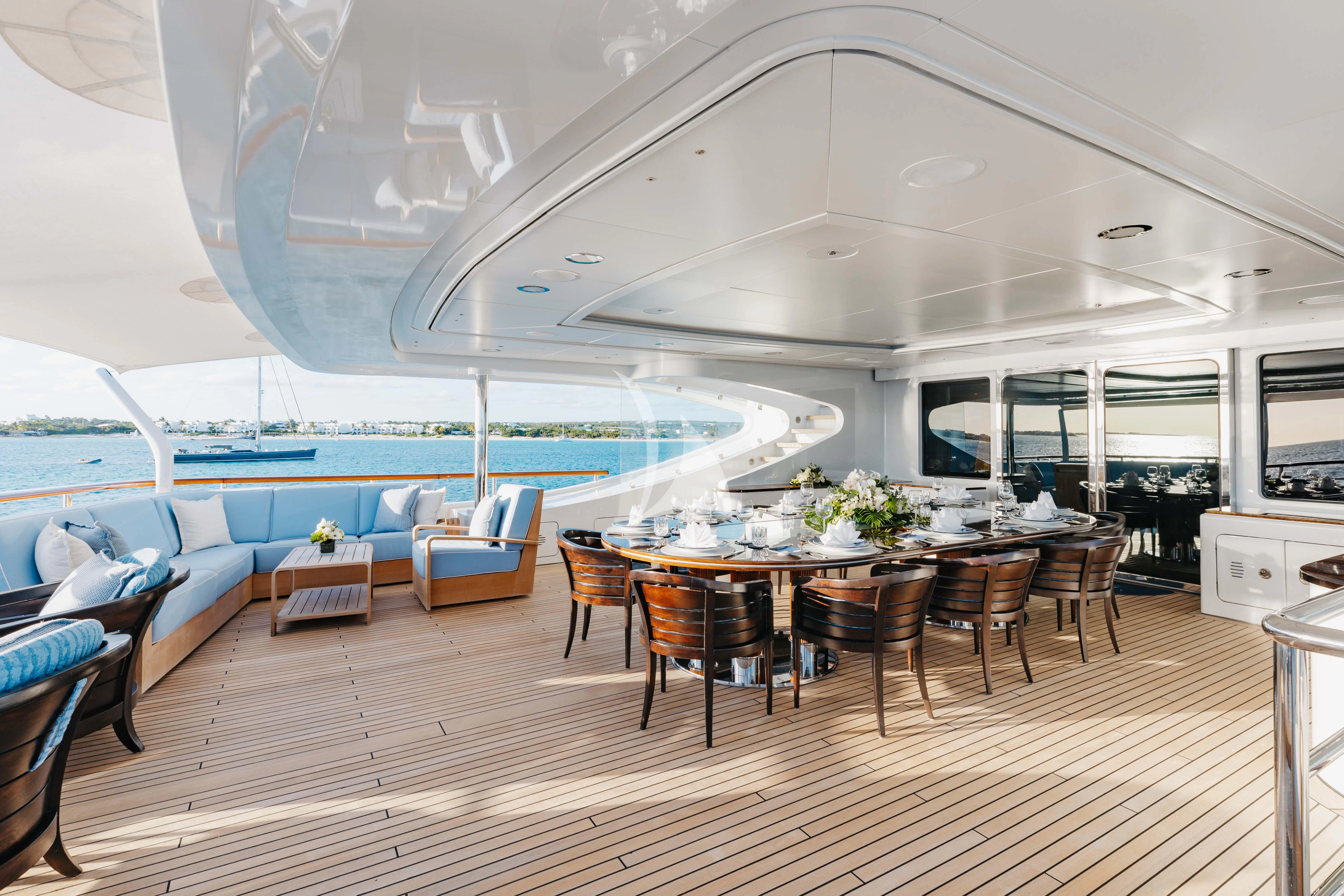 a large room with a table and chairs and a pool aboard LADY B Yacht for Charter