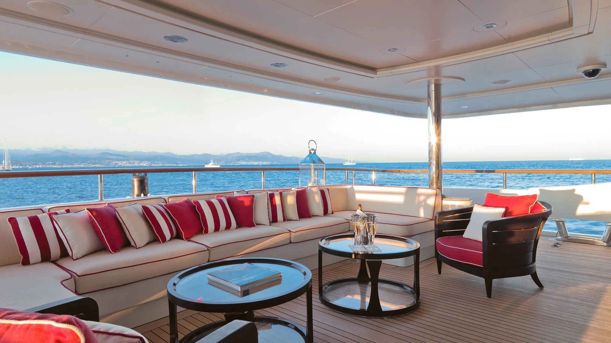 a living room with a large body of water in the background aboard LADY B Yacht for Charter