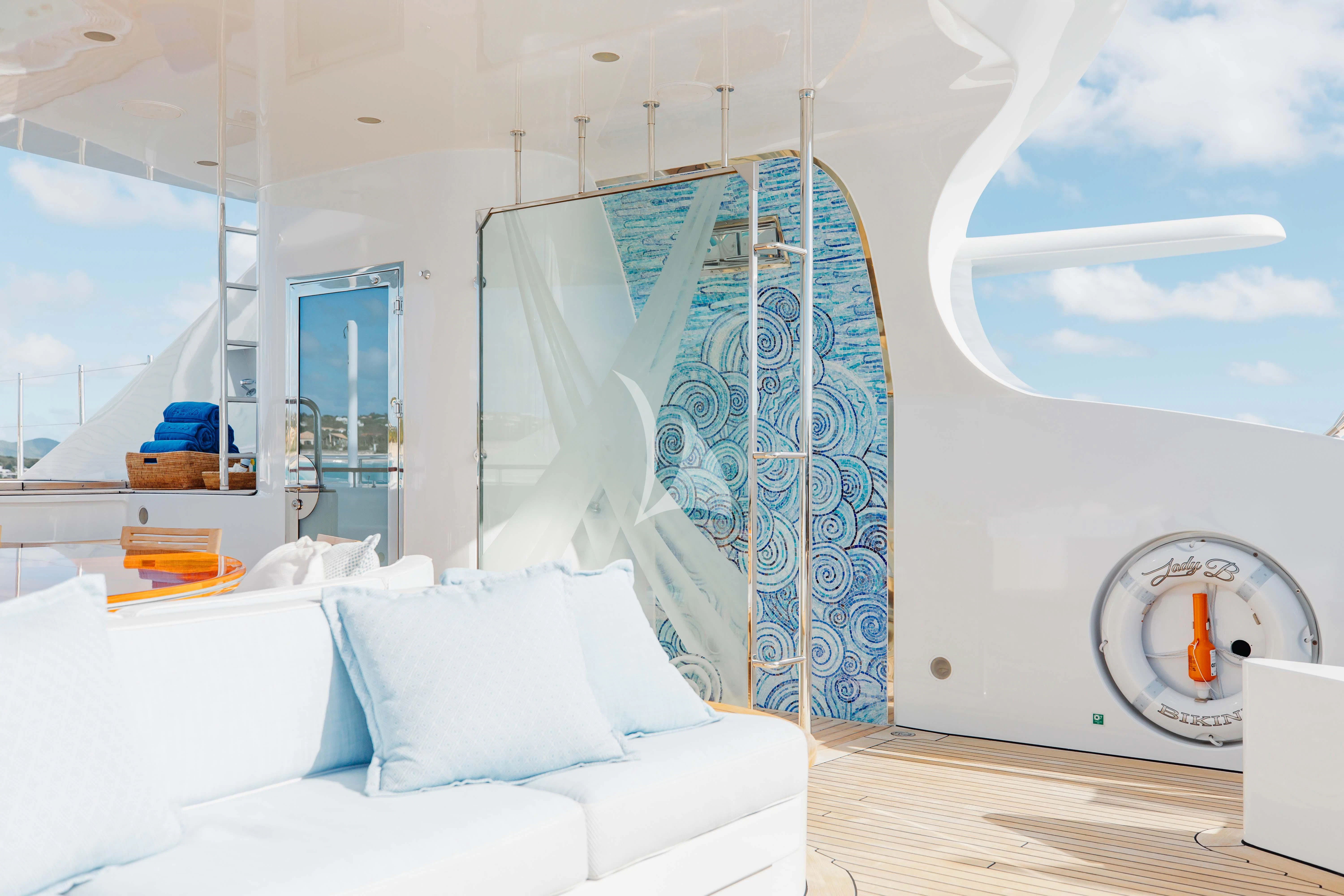 a room with a bed and a couch aboard LADY B Yacht for Charter