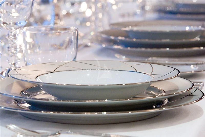 a stack of plates aboard LADY B Yacht for Charter