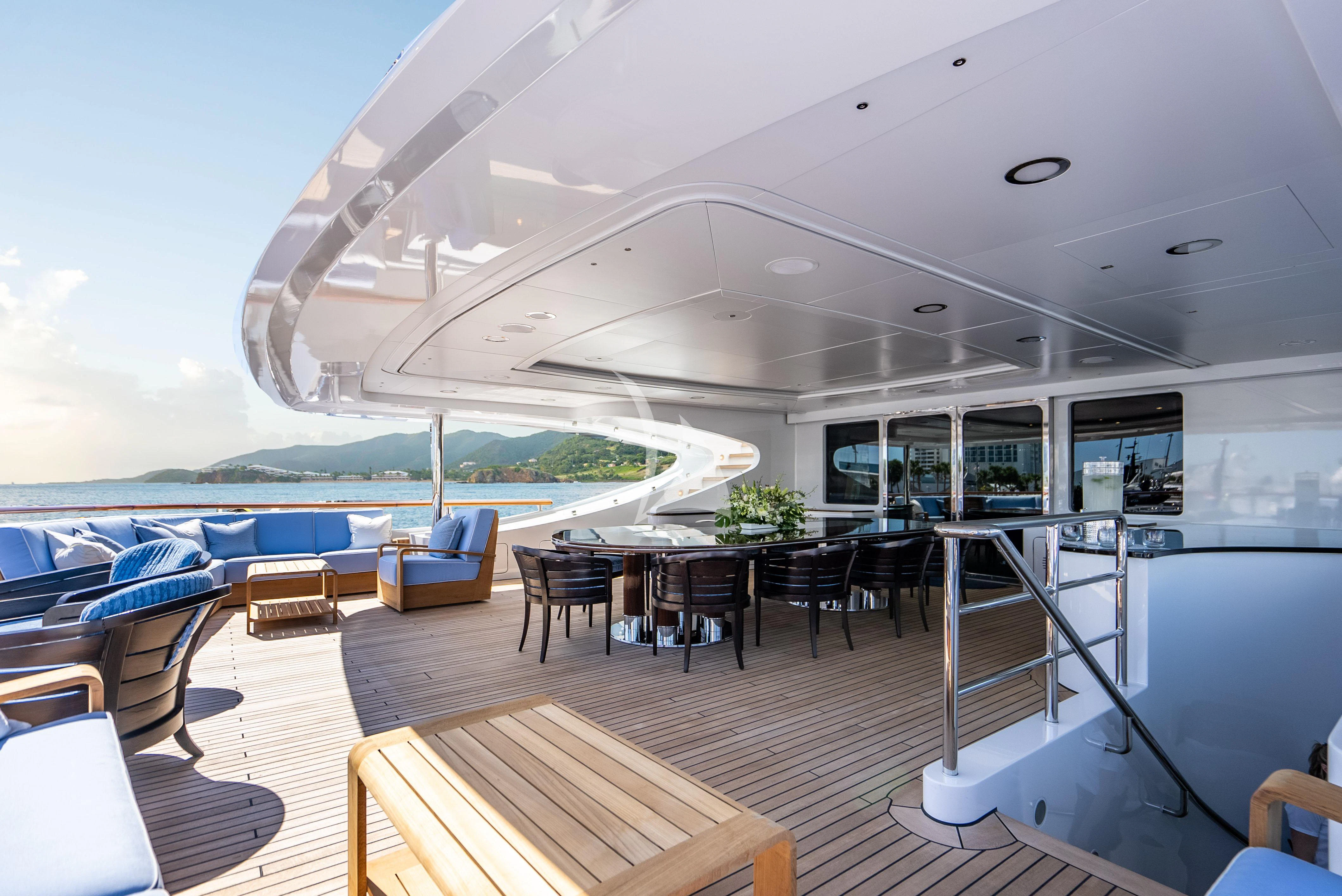 a room with a pool and a deck with chairs and a table aboard LADY B Yacht for Charter
