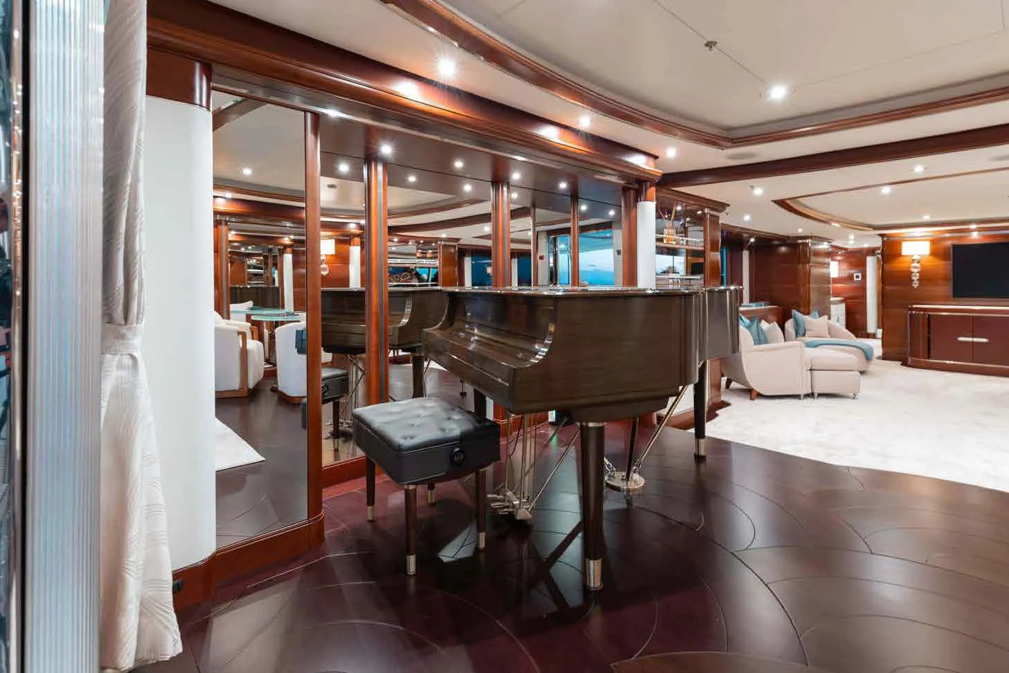 a large room with a piano and a piano aboard LADY B Yacht for Charter