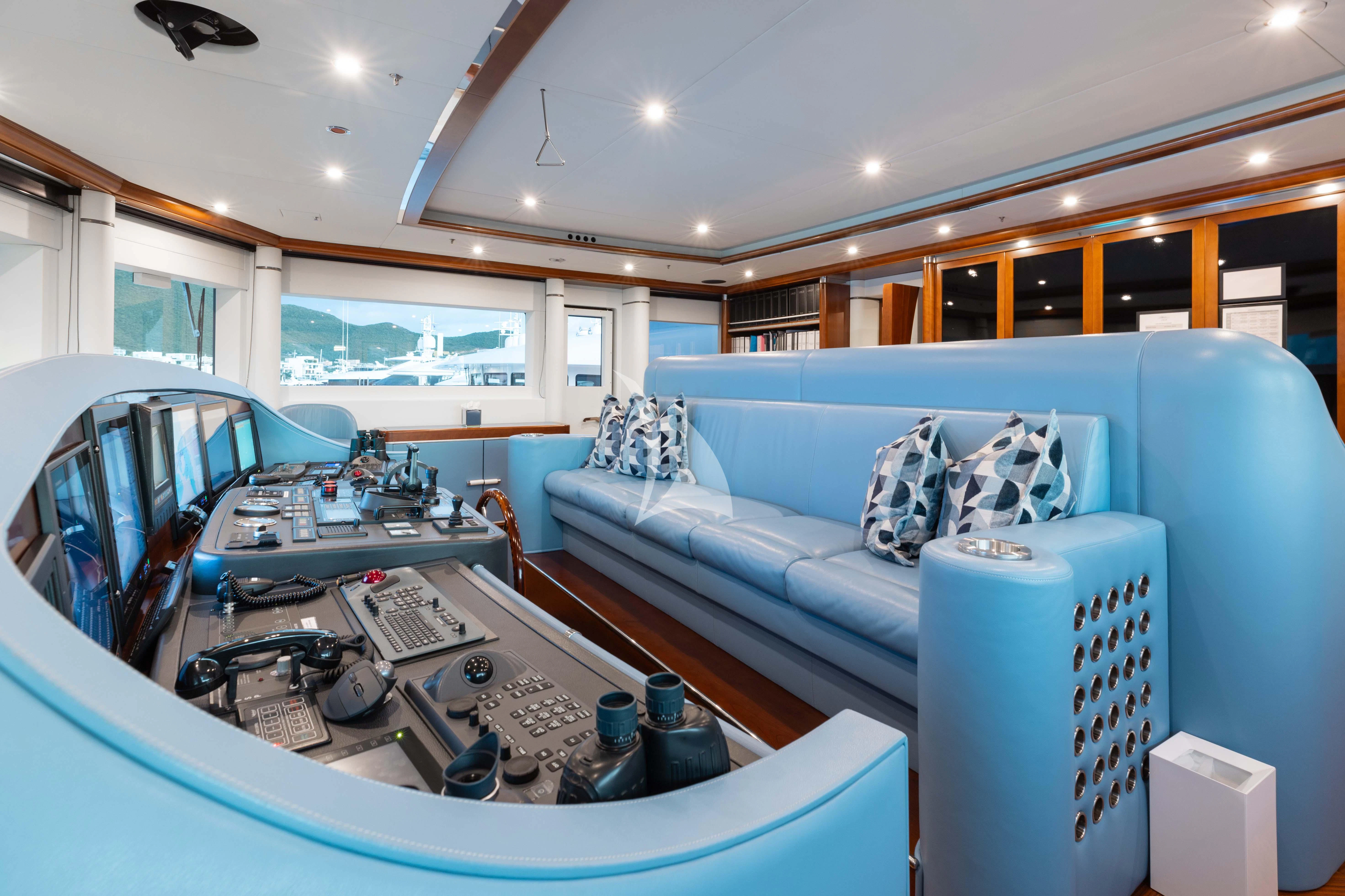 a living room with a blue couch and a white sofa aboard LADY B Yacht for Charter