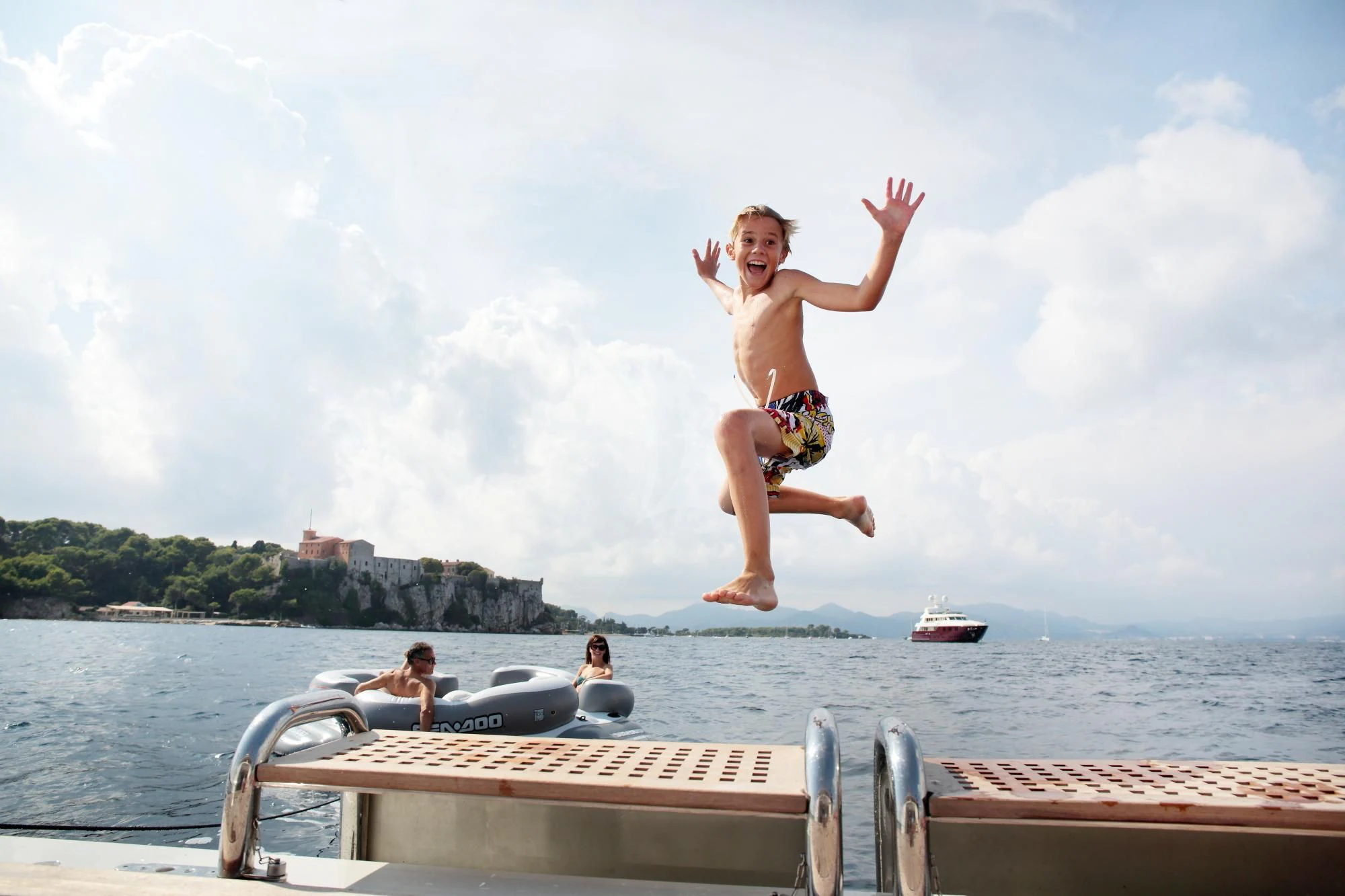 a person jumping off a dock into the water aboard LADY B Yacht for Charter