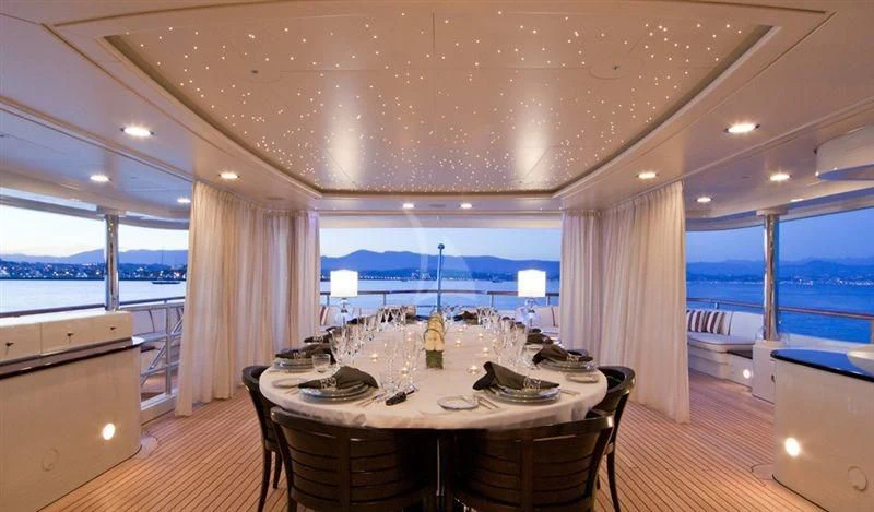a large dining table in a room aboard LADY B Yacht for Charter