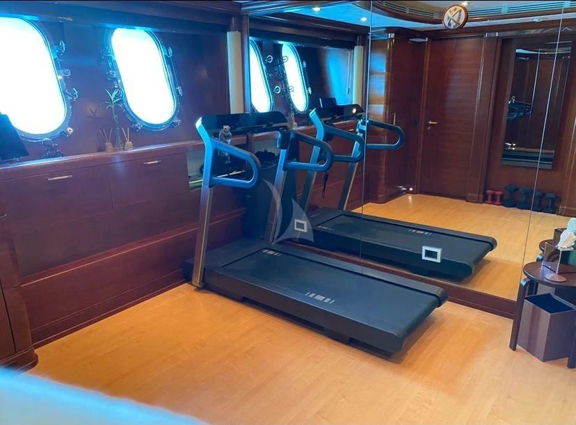 a black and blue treadmill aboard LADY B Yacht for Charter