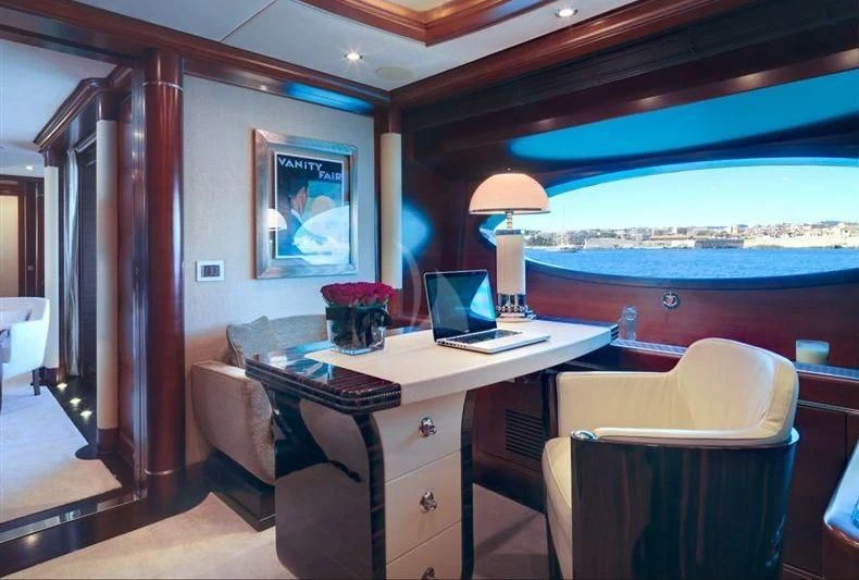 a room with a desk and a window aboard LADY B Yacht for Charter