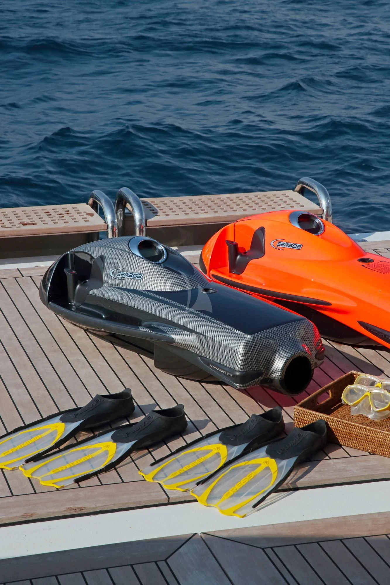 a yellow and orange kayak on a deck by the water aboard LADY B Yacht for Charter