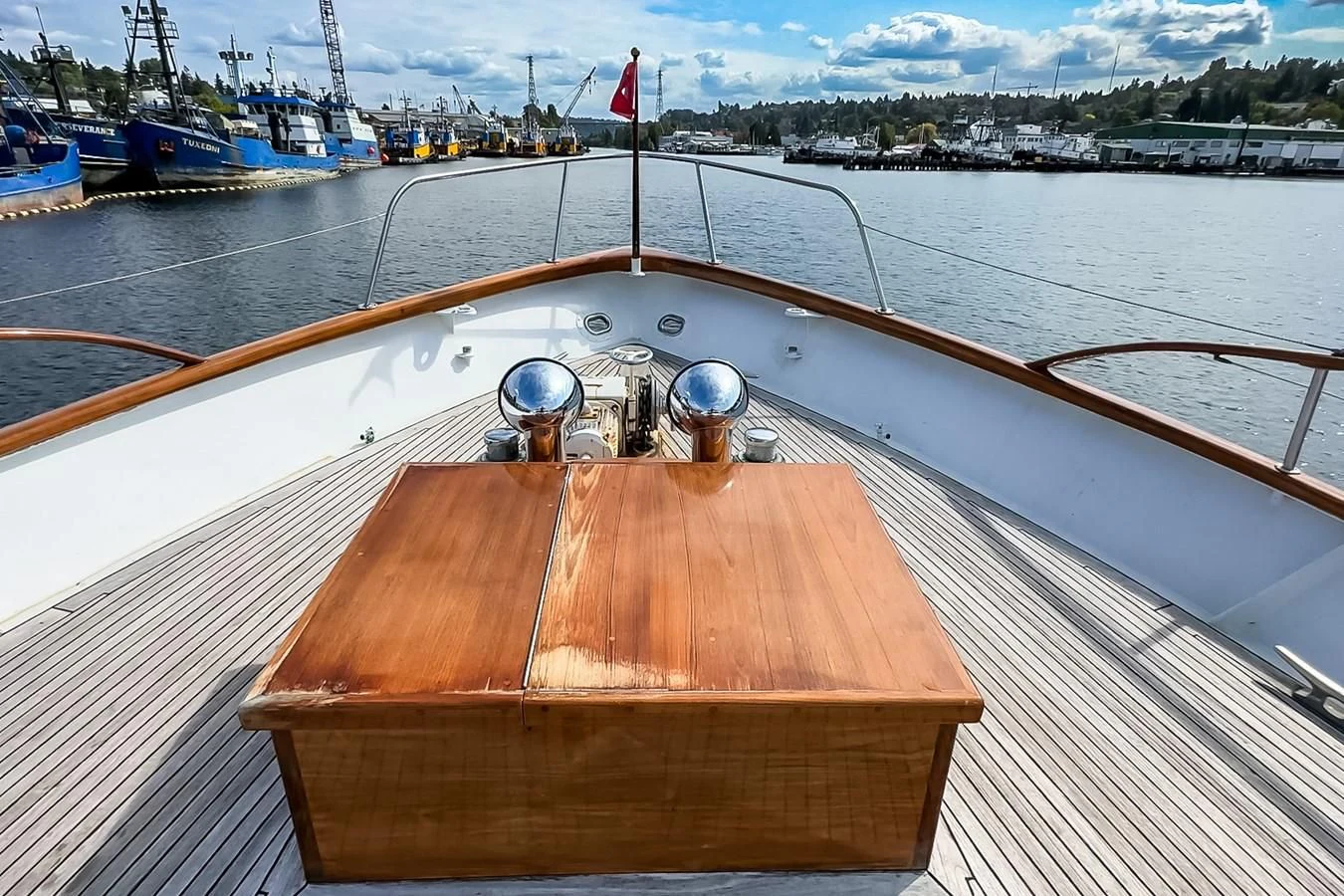 a wooden deck with a large ship in the background aboard SEA STAR Yacht for Sale