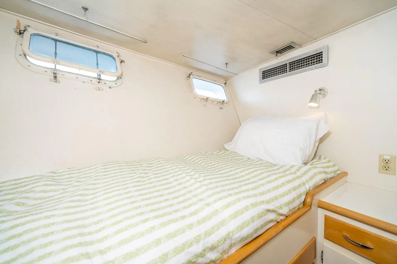 a bed with a white sheet aboard SEA STAR Yacht for Sale