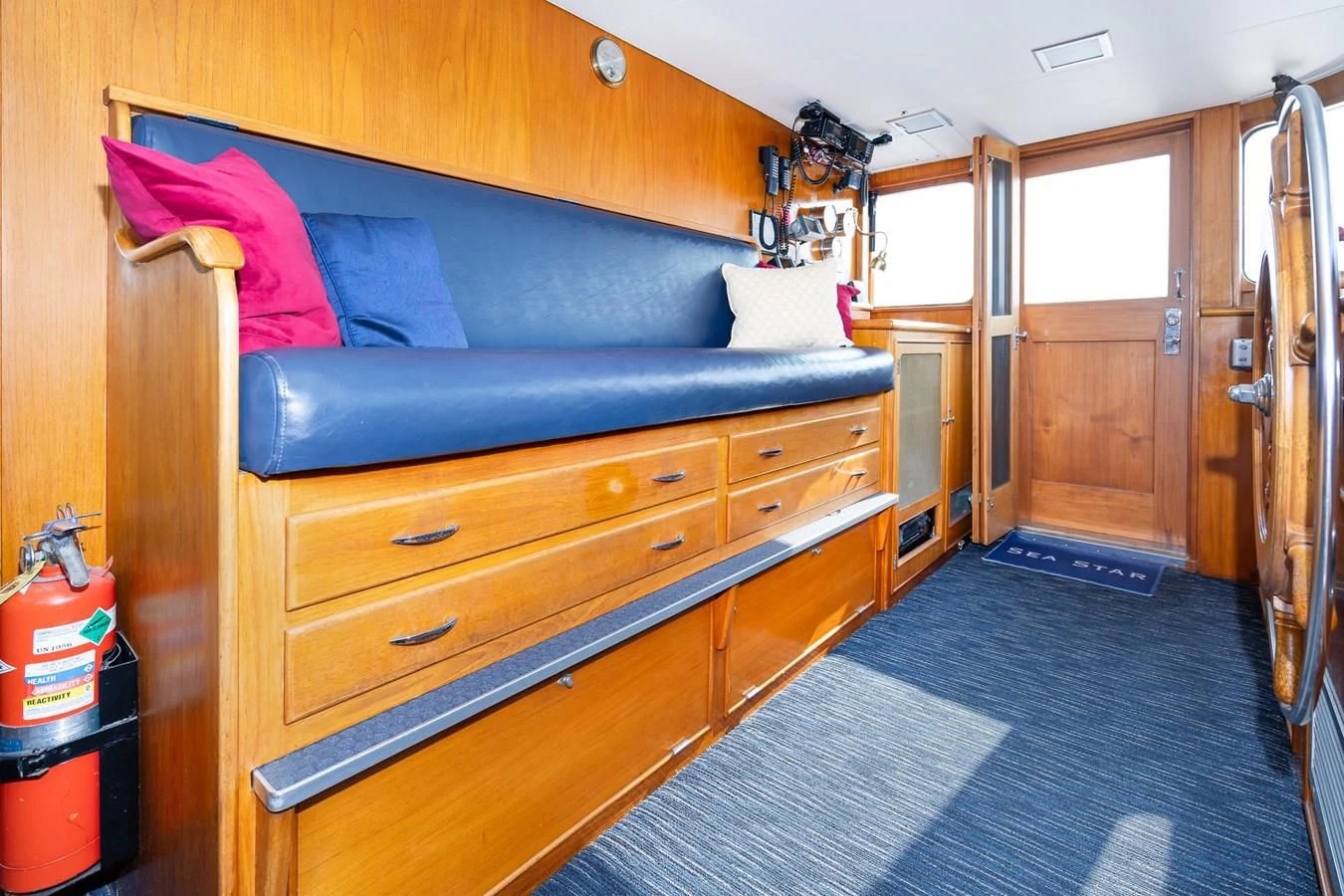 a room with a couch and a dresser aboard SEA STAR Yacht for Sale