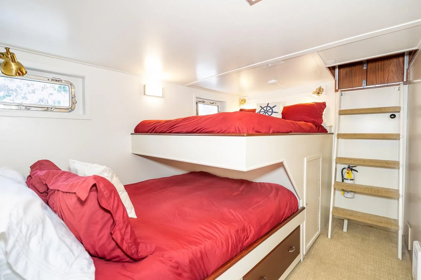 a bedroom with a bed and a shelf aboard SEA STAR Yacht for Sale