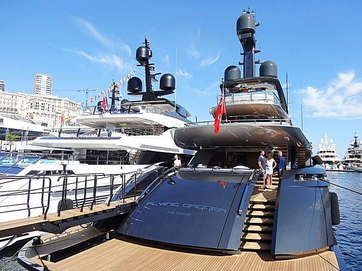 a large boat with a group of people on it aboard FLYING DAGGER III Yacht for Sale