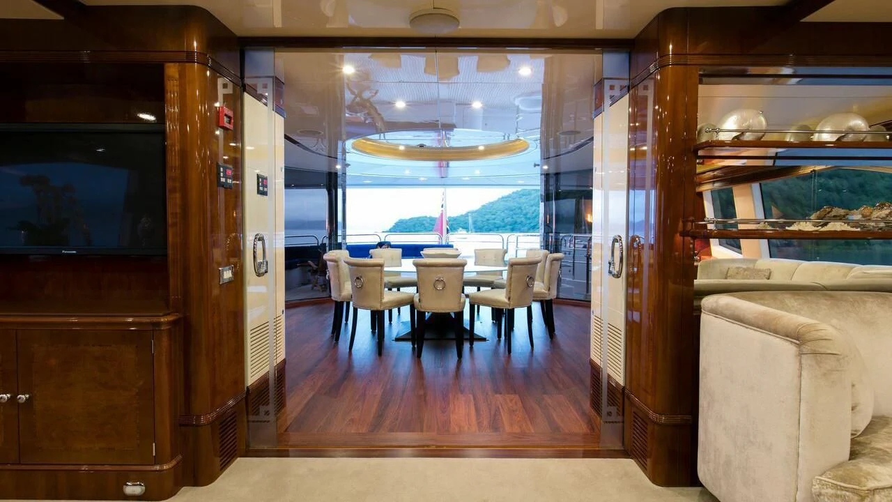 a room with a table and chairs aboard THE STAR Yacht for Sale