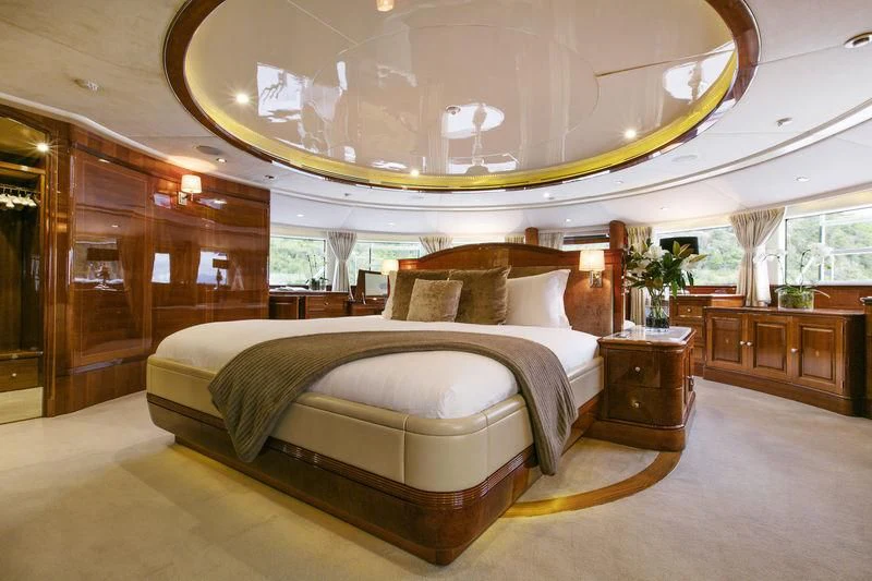 a large bed in a room aboard THE STAR Yacht for Sale