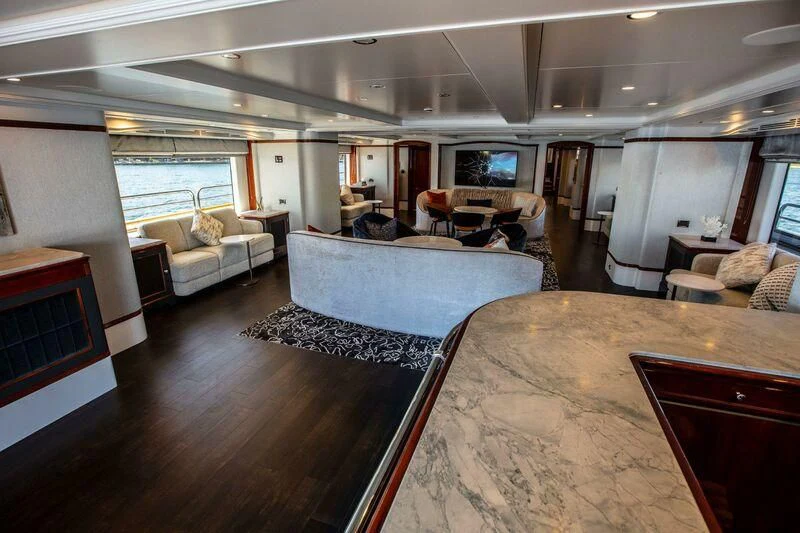 a large living room with a large bed and a large window aboard THE STAR Yacht for Sale