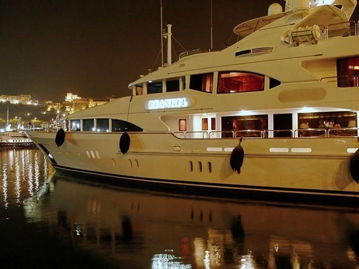 a large white boat in a harbor aboard THE STAR Yacht for Sale