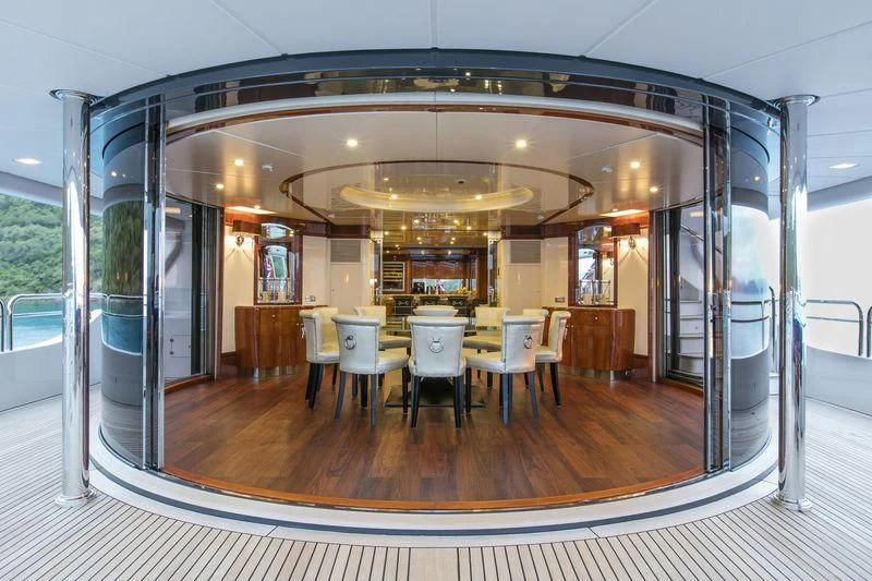 a large room with tables and chairs aboard THE STAR Yacht for Sale