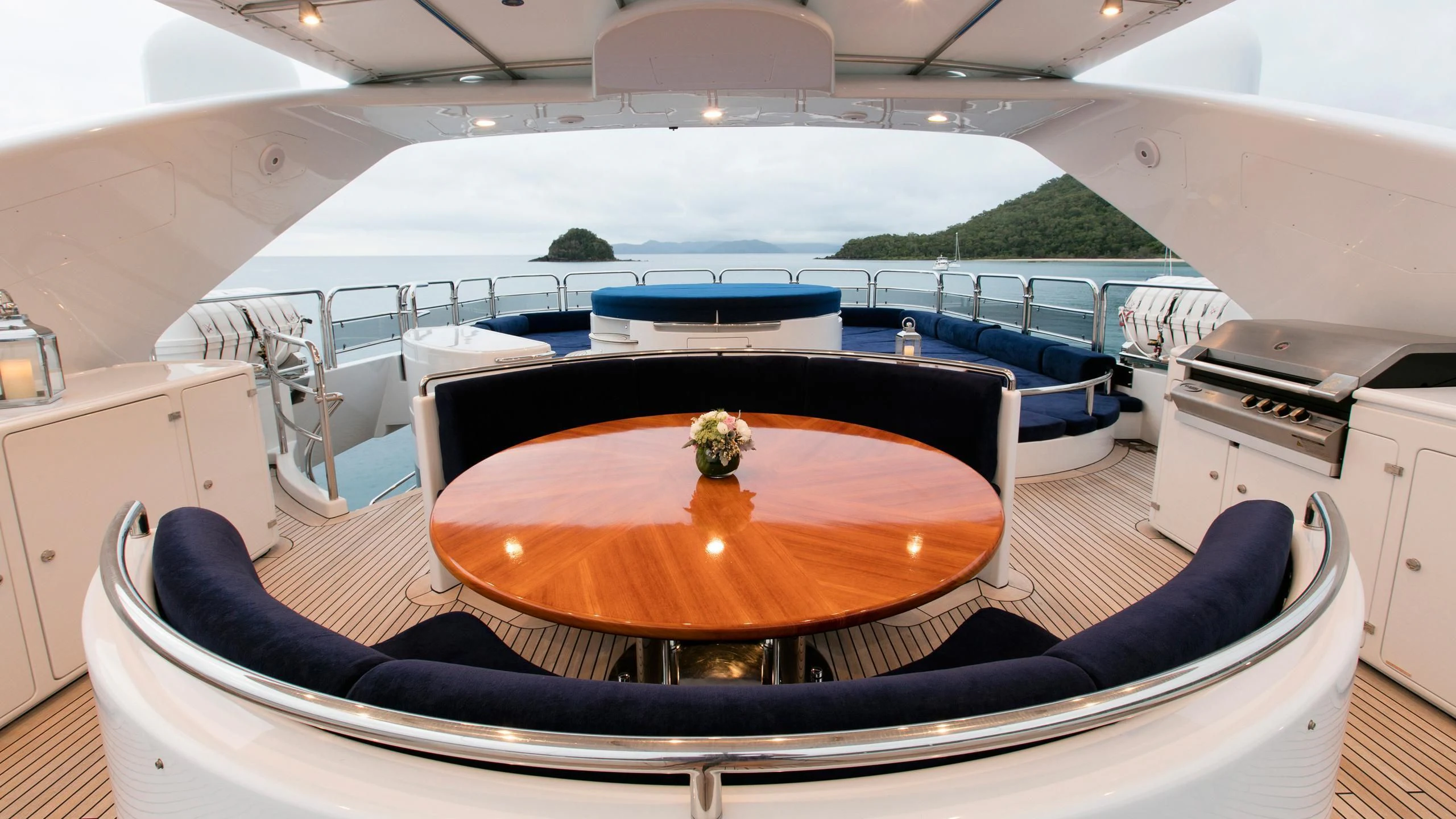 a large white yacht with a table and chairs aboard THE STAR Yacht for Sale