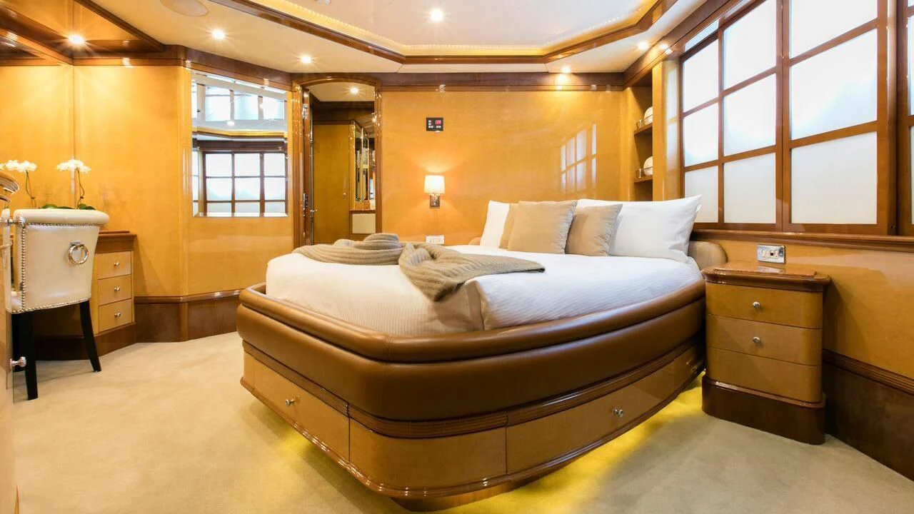 a large bed in a room aboard THE STAR Yacht for Sale