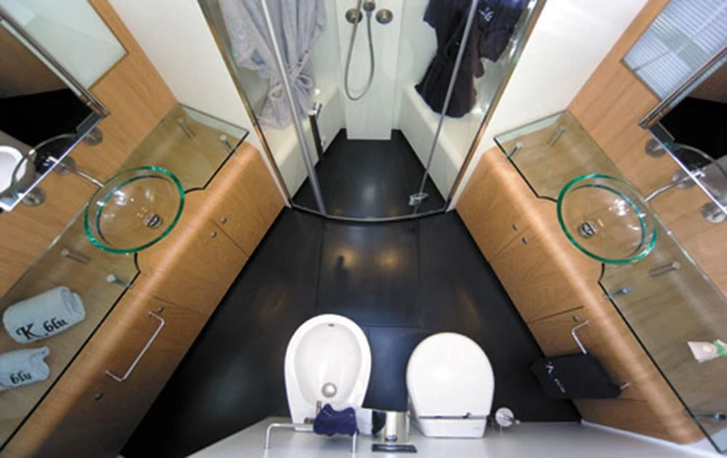 a kitchen with a countertop sink and a large mirror aboard CNM CONTINENTAL 80 Yacht for Sale