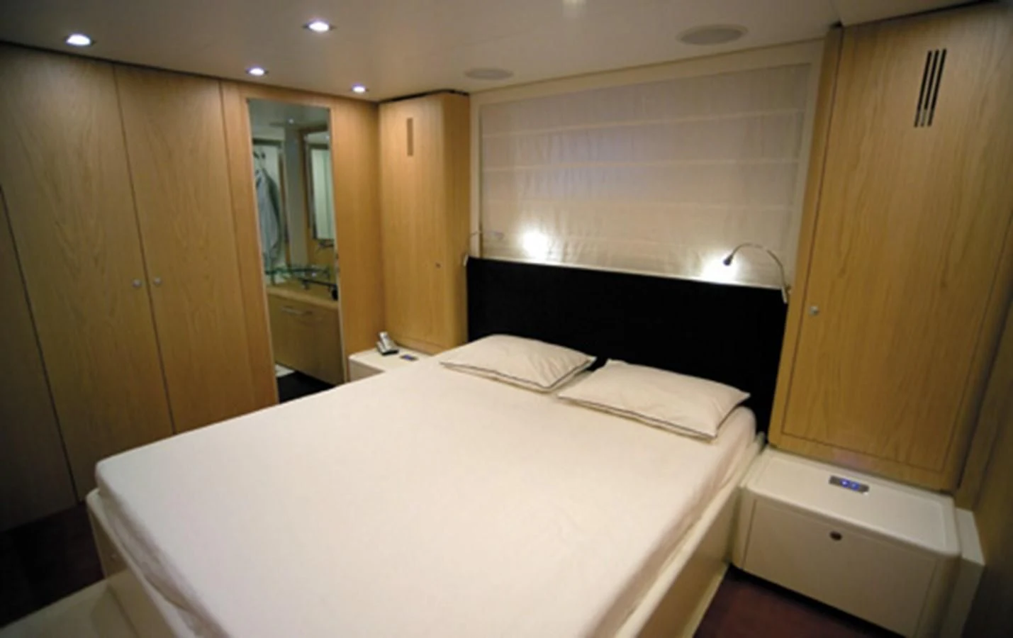 a room with a bed and a closet aboard CNM CONTINENTAL 80 Yacht for Sale