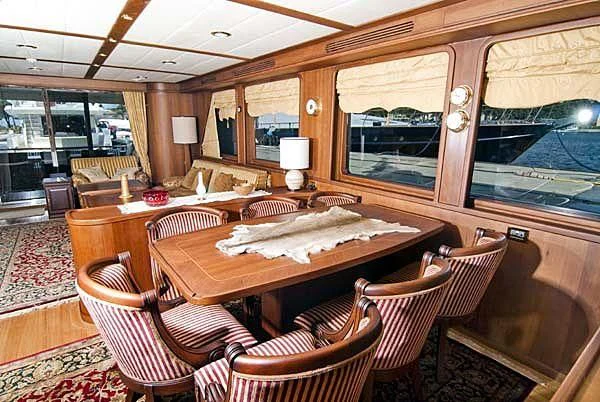 a dining table in a room aboard KUYIS Yacht for Sale