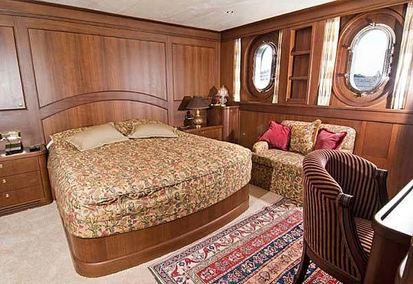a bedroom with a bed and a couch aboard KUYIS Yacht for Sale