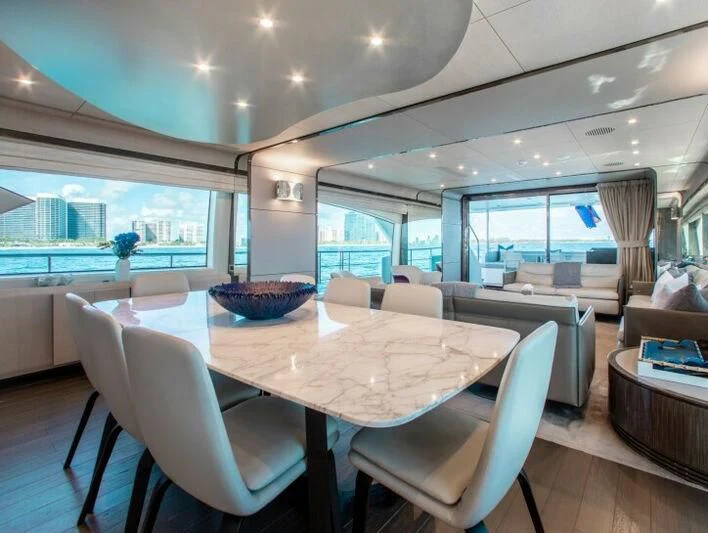 a large dining room with a large table and chairs aboard INDIGO Yacht for Sale