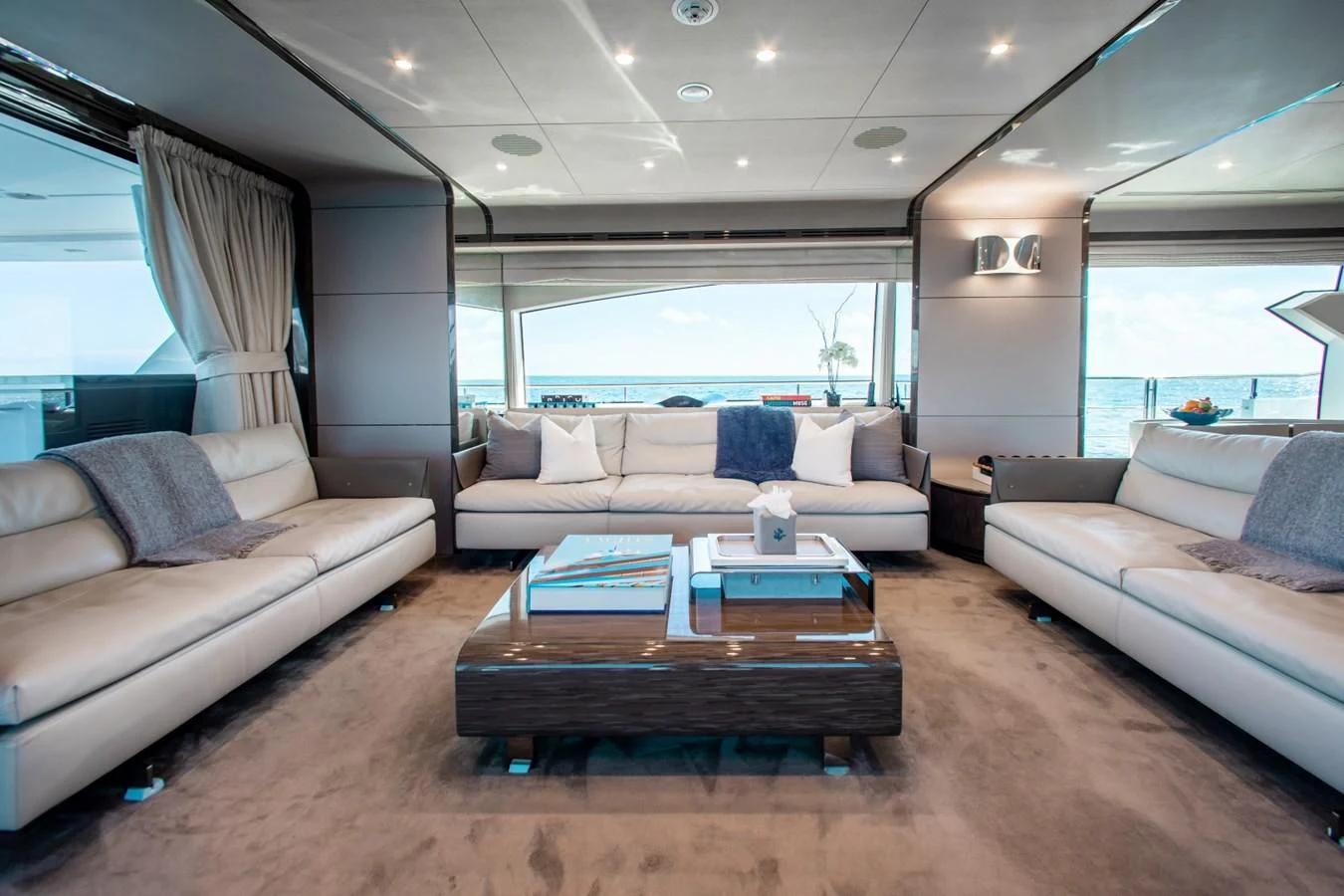 a living room with a couch and a coffee table aboard INDIGO Yacht for Sale