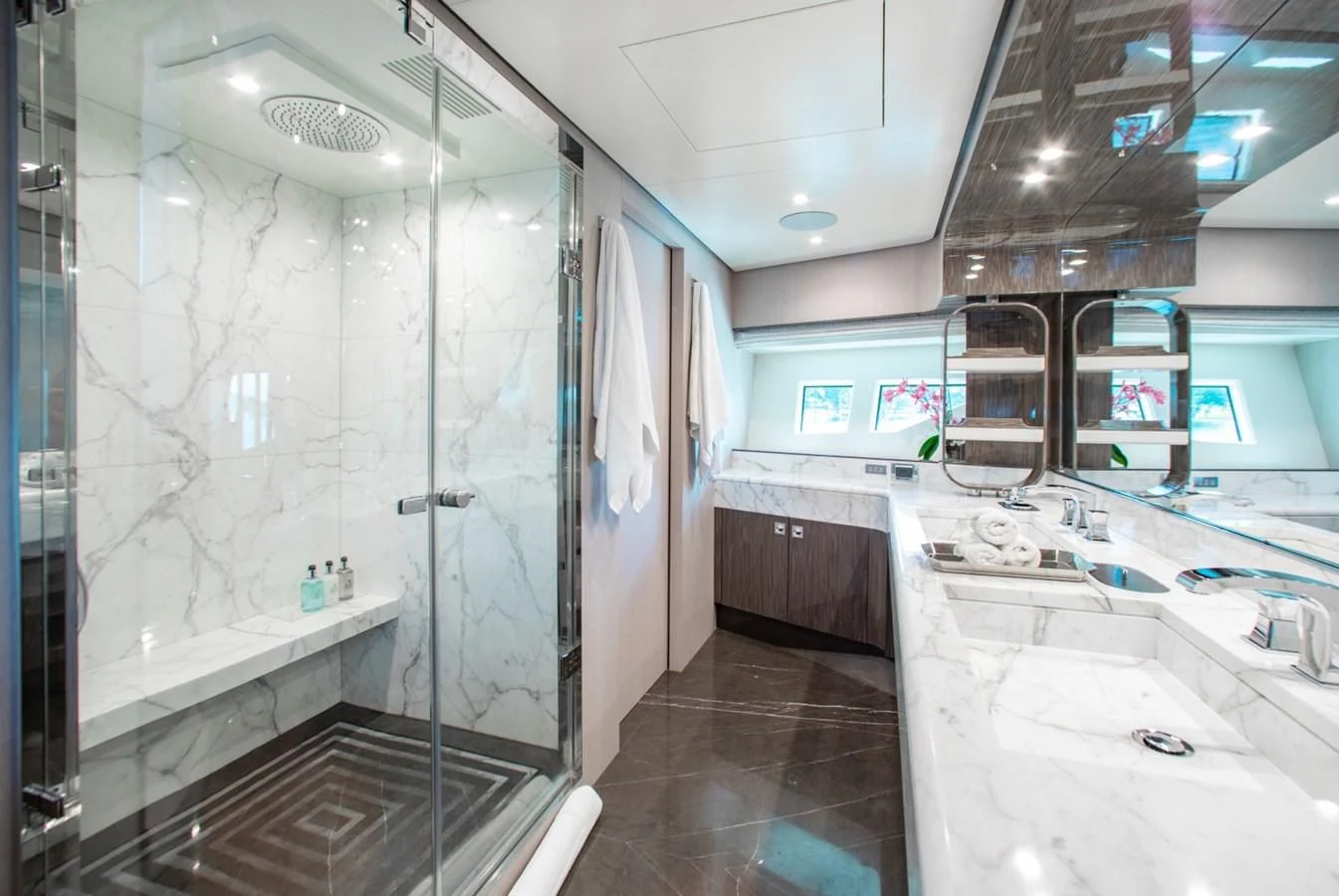 a bathroom with a glass shower aboard INDIGO Yacht for Sale