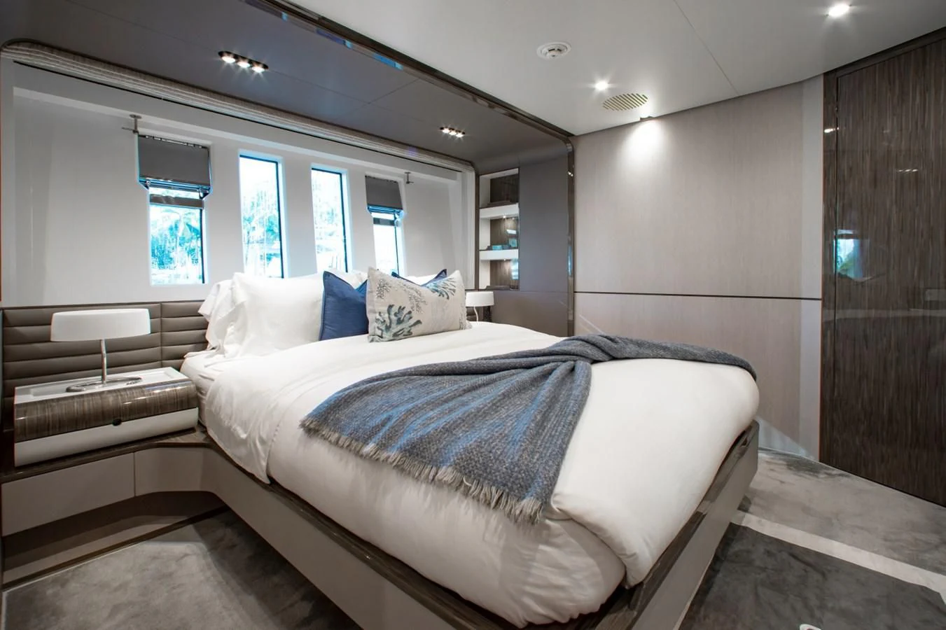 a room with a bed and a wood door aboard INDIGO Yacht for Sale