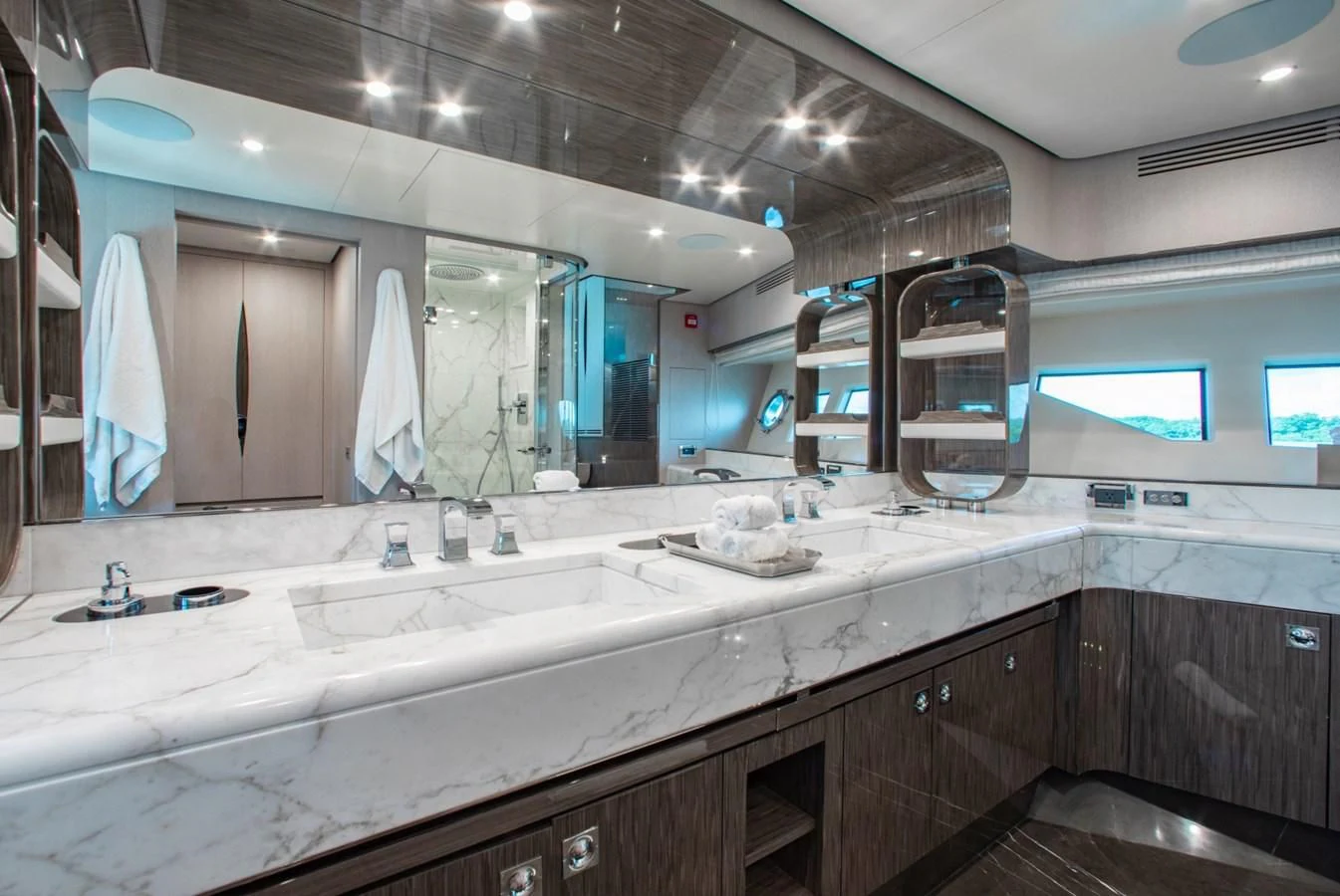 a large bathroom with a large mirror aboard INDIGO Yacht for Sale