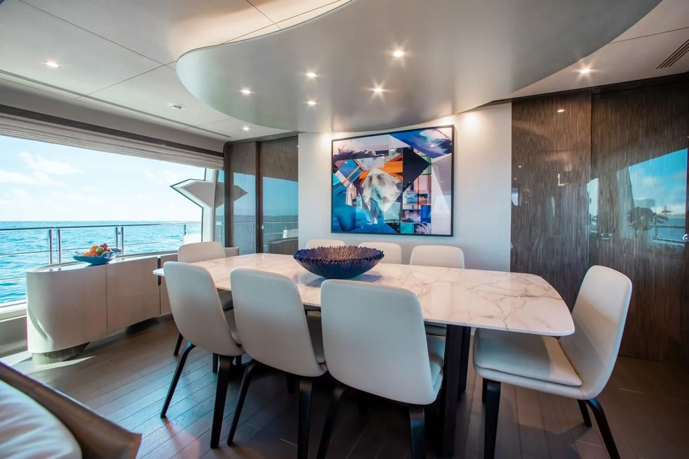 a large modern kitchen with a large table and chairs aboard INDIGO Yacht for Sale