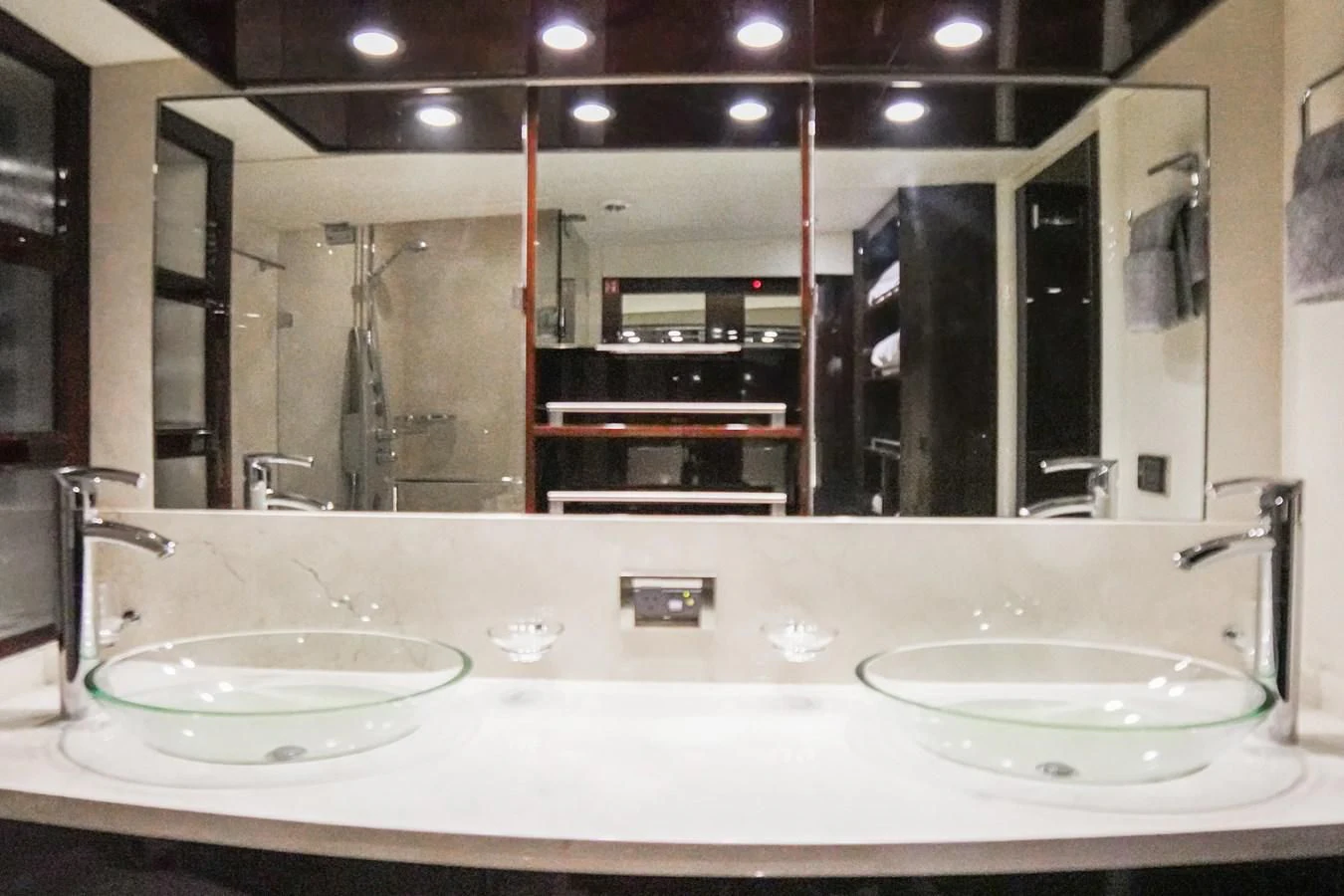 a bathroom with sinks and mirrors aboard LAZZARA 68' Yacht for Sale